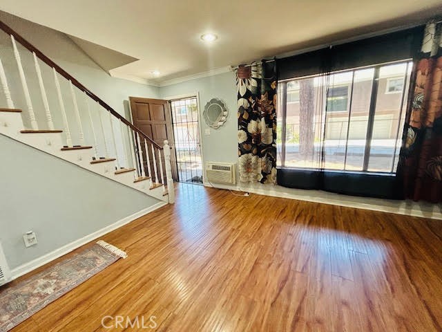 7304 Exeter Street, Unit E Paramount, CA 90723 - Photo 12 of 36 The living room features a clear view of the beautifully designed staircase, creating a striking focal point.