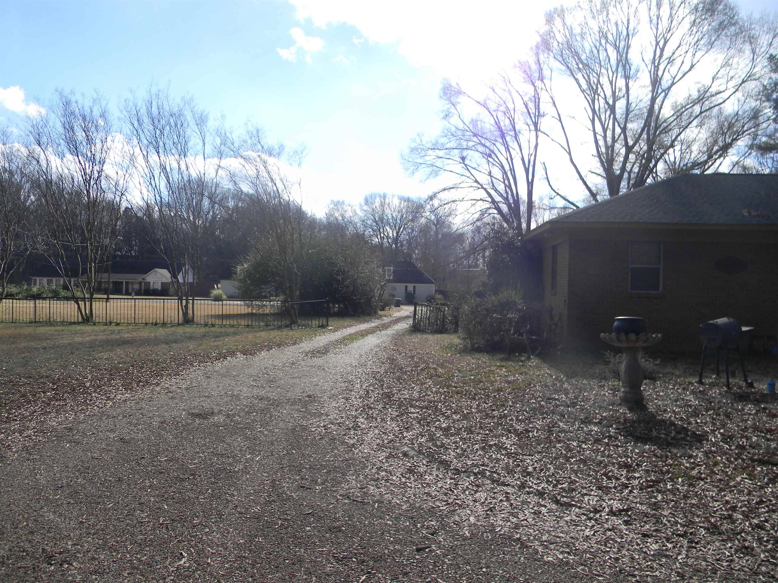 5558 Crestview Road Memphis, TN 38134 - Photo 16 of 32 a backyard of a house with lots of green space