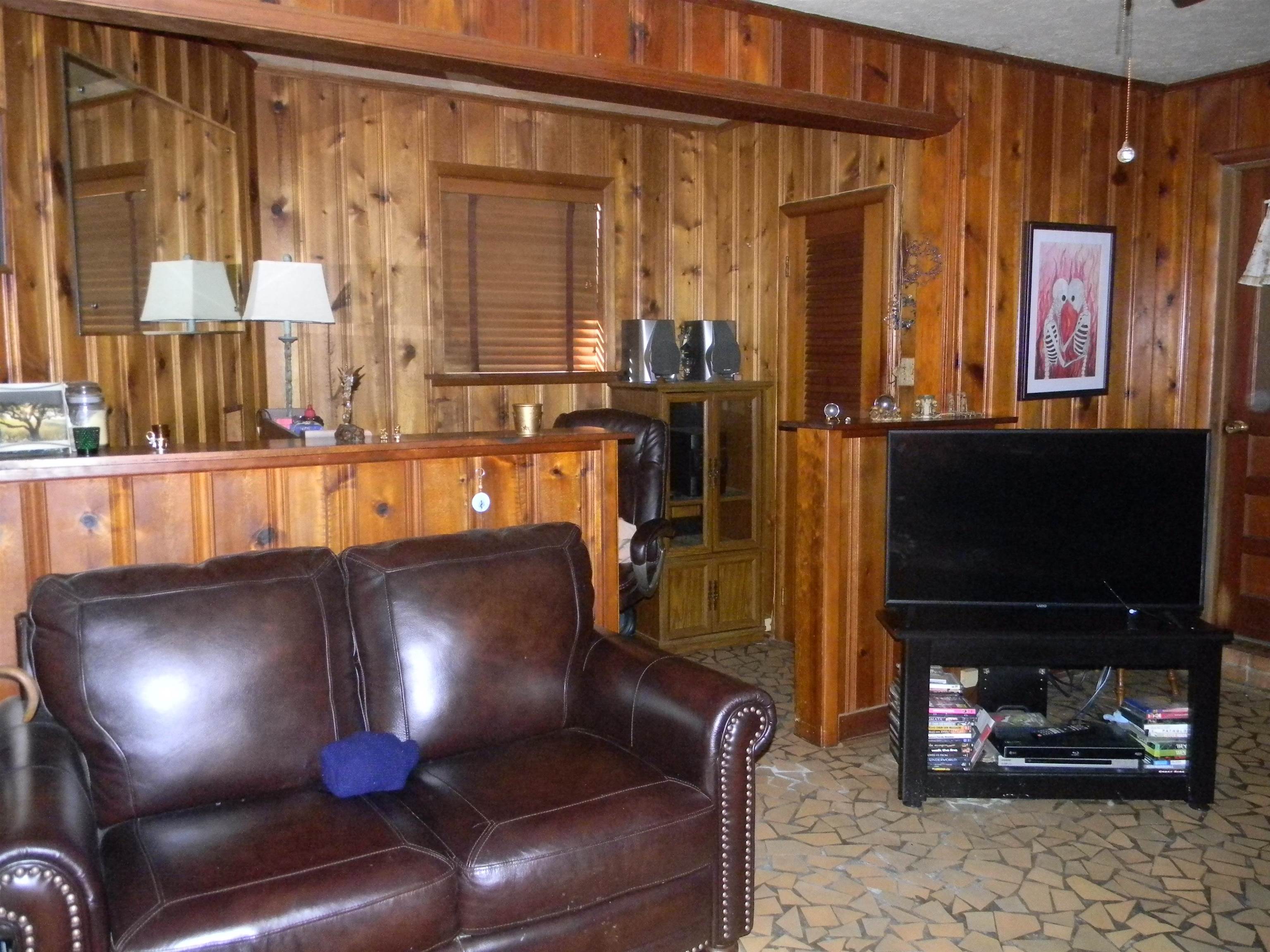 5558 Crestview Road Memphis, TN 38134 - Photo 17 of 32 a living room with furniture and a flat screen tv