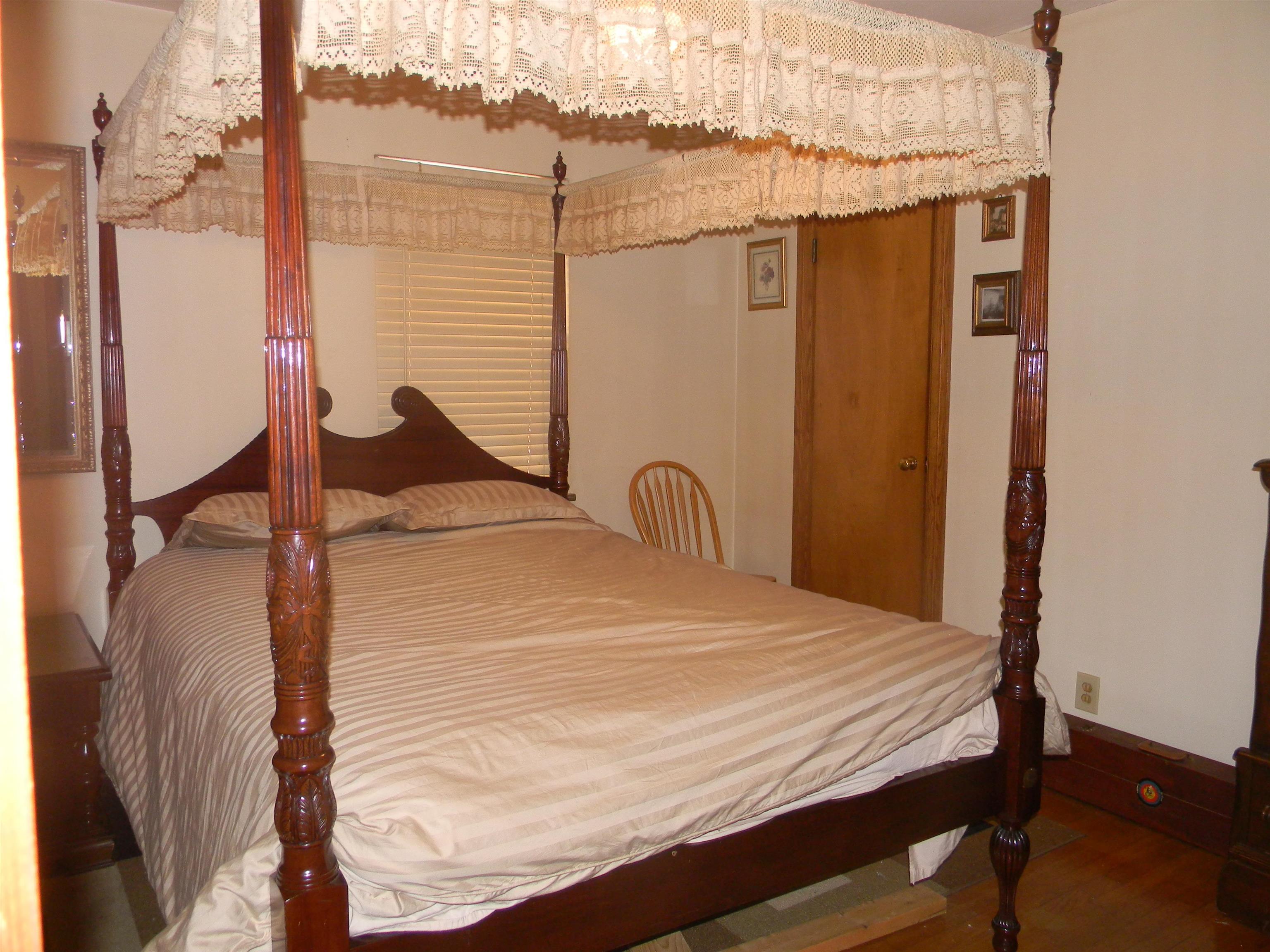 5558 Crestview Road Memphis, TN 38134 - Photo 27 of 32 a bed sitting in a bedroom next to a bathroom
