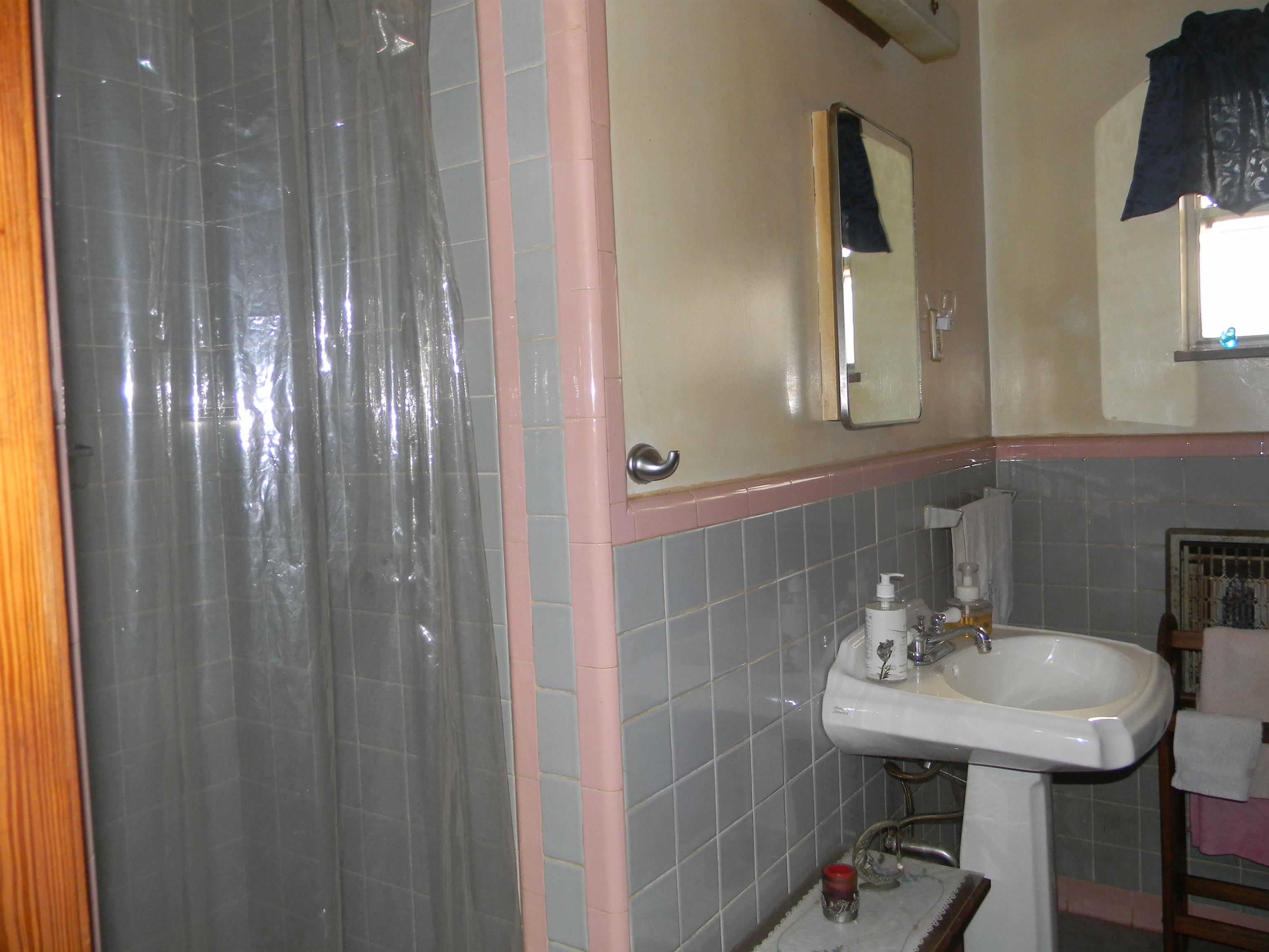 5558 Crestview Road Memphis, TN 38134 - Photo 29 of 32 a bathroom with a sink a mirror and a shower