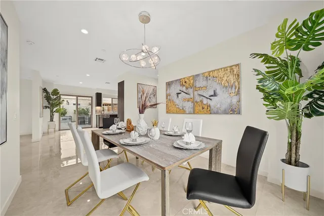 a view of a dining room with furniture wooden floor and a chandelier