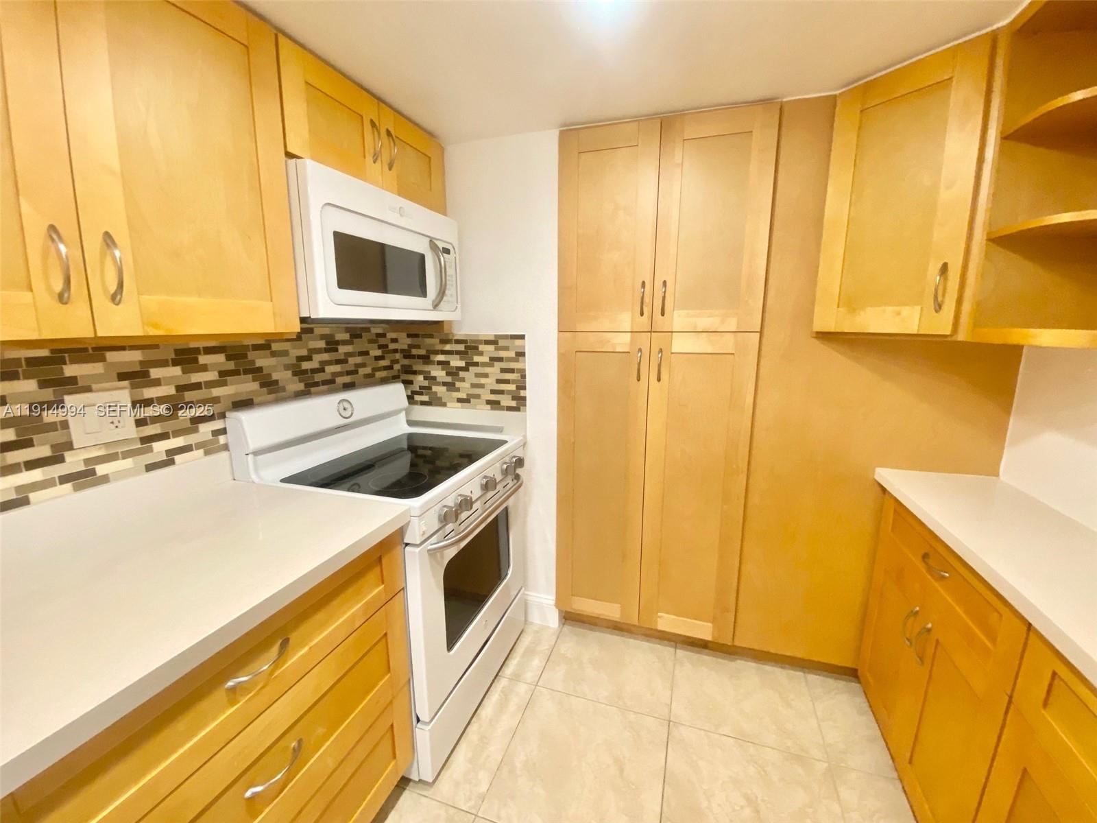 6568 Southwest 41st Place, Unit 151 Davie, FL 33314 - Photo 12 of 65 a bathroom with a sink and a washing machine