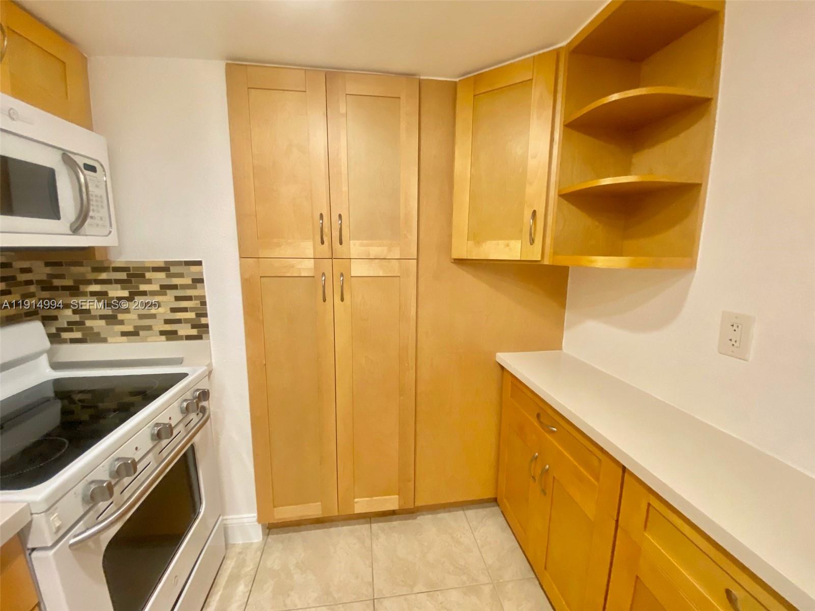 6568 Southwest 41st Place, Unit 151 Davie, FL 33314 - Photo 13 of 65 a kitchen with a sink and a refrigerator