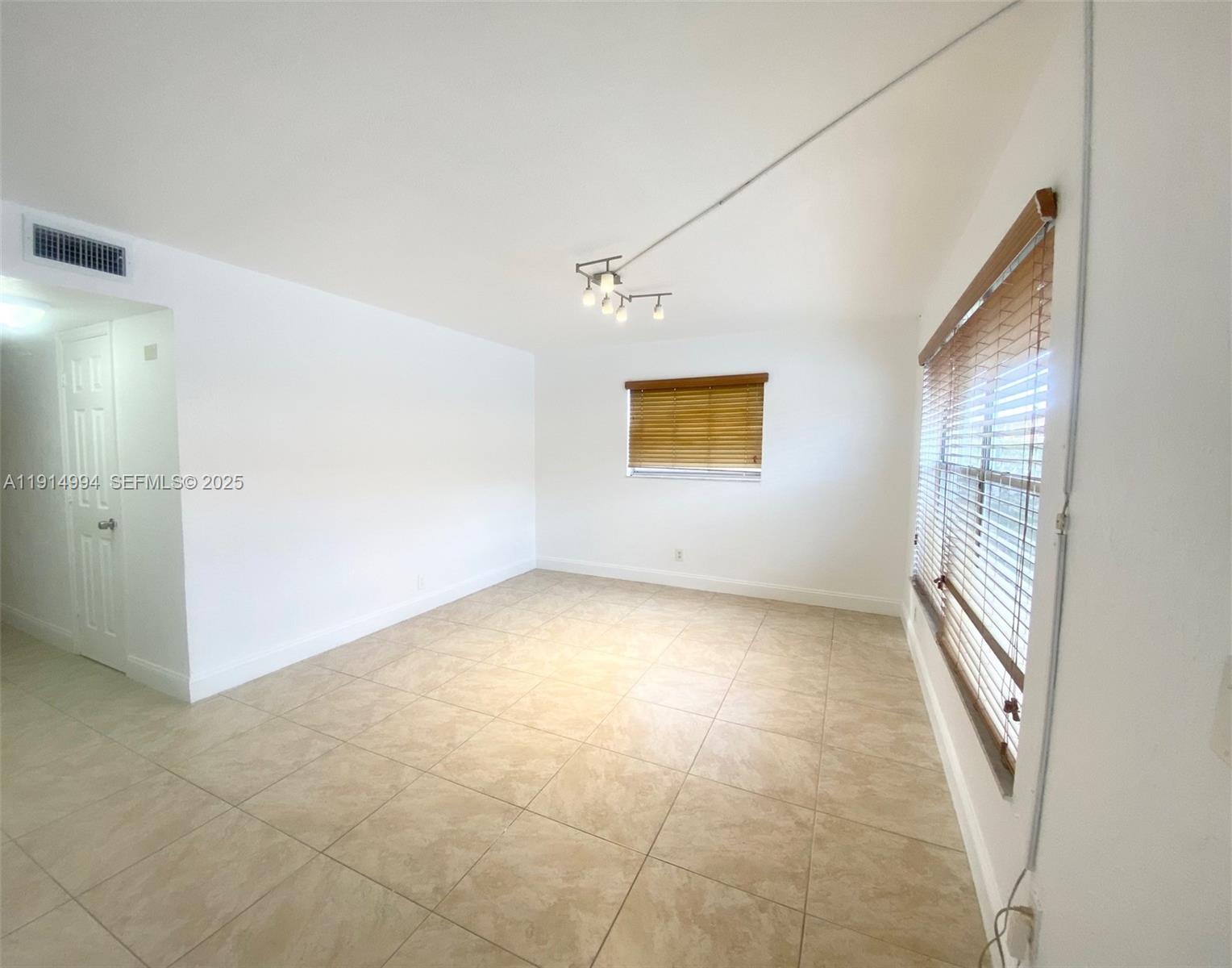 6568 Southwest 41st Place, Unit 151 Davie, FL 33314 - Photo 15 of 65 an empty room with windows and closet