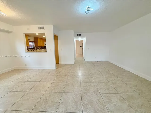 a kitchen with stainless steel appliances granite countertop a refrigerator a stove and a sink