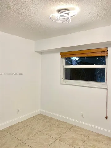 a kitchen with granite countertop white cabinets and sink
