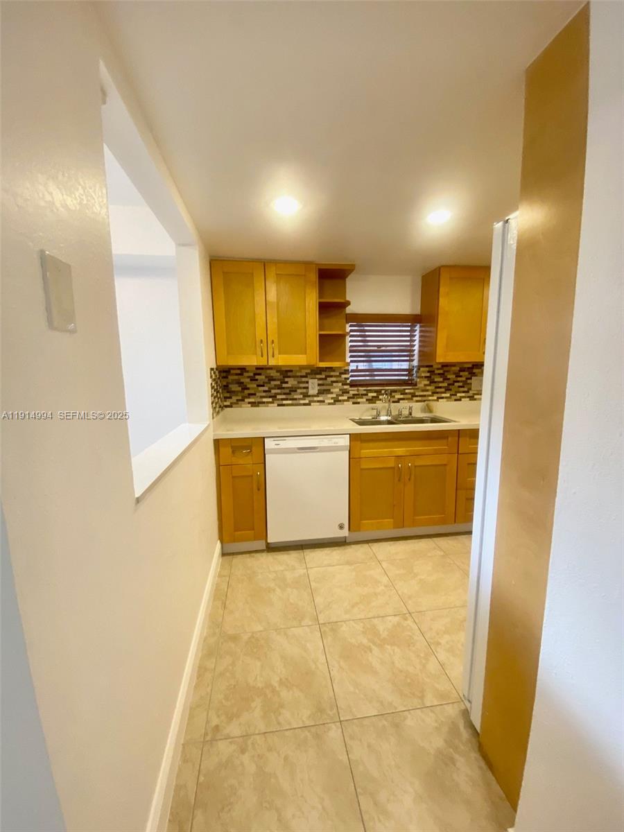 6568 Southwest 41st Place, Unit 151 Davie, FL 33314 - Photo 24 of 65 a kitchen with stainless steel appliances granite countertop a refrigerator a stove and a sink