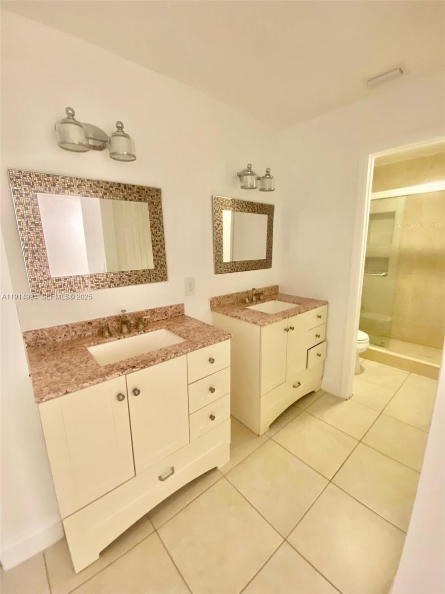 6568 Southwest 41st Place, Unit 151 Davie, FL 33314 - Photo 30 of 65 a kitchen with granite countertop white cabinets and sink