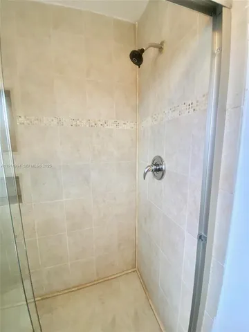 a bathroom with a granite countertop sink toilet tub and shower