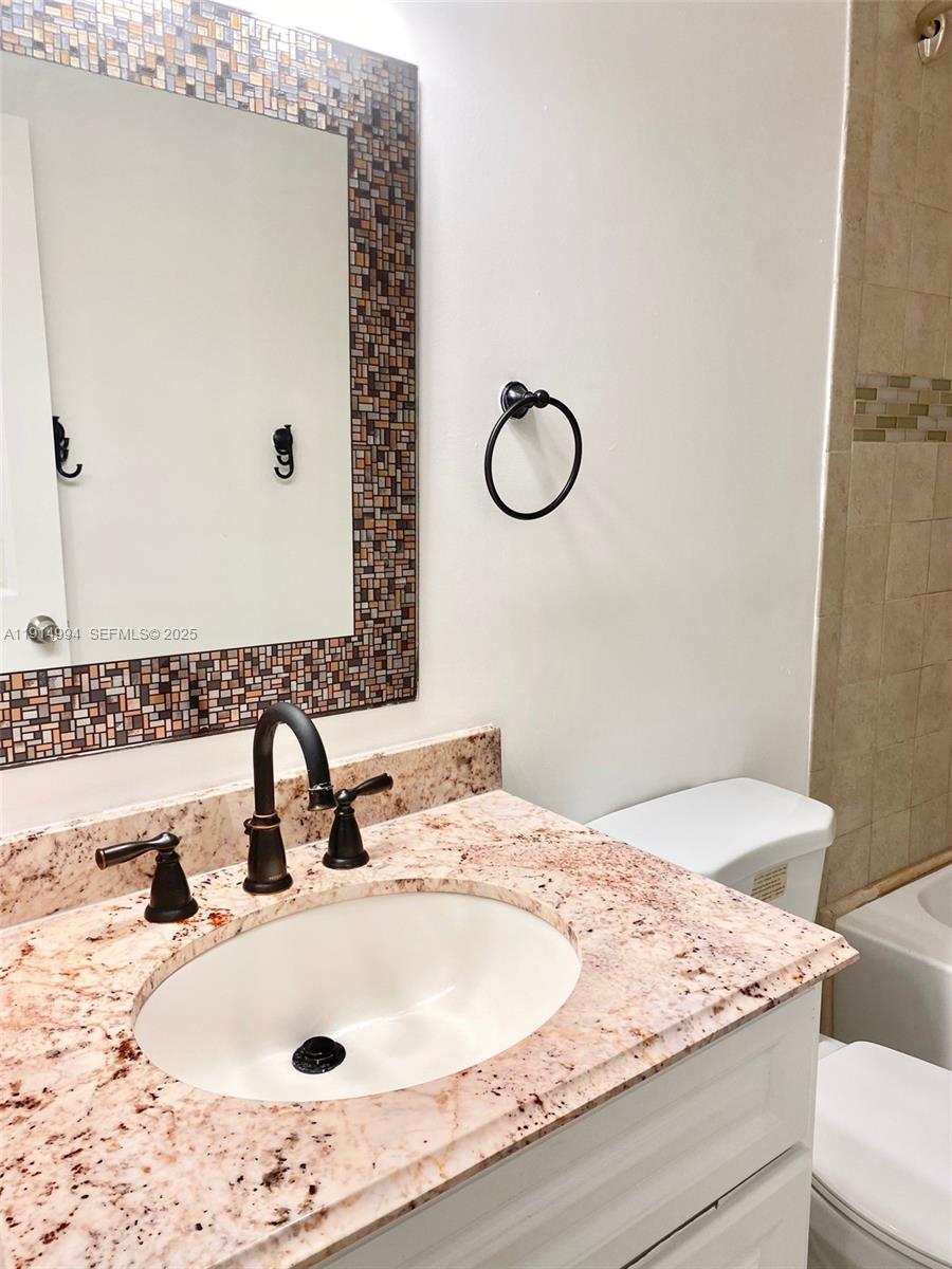 6568 Southwest 41st Place, Unit 151 Davie, FL 33314 - Photo 44 of 65 a bathroom with a sink and a mirror
