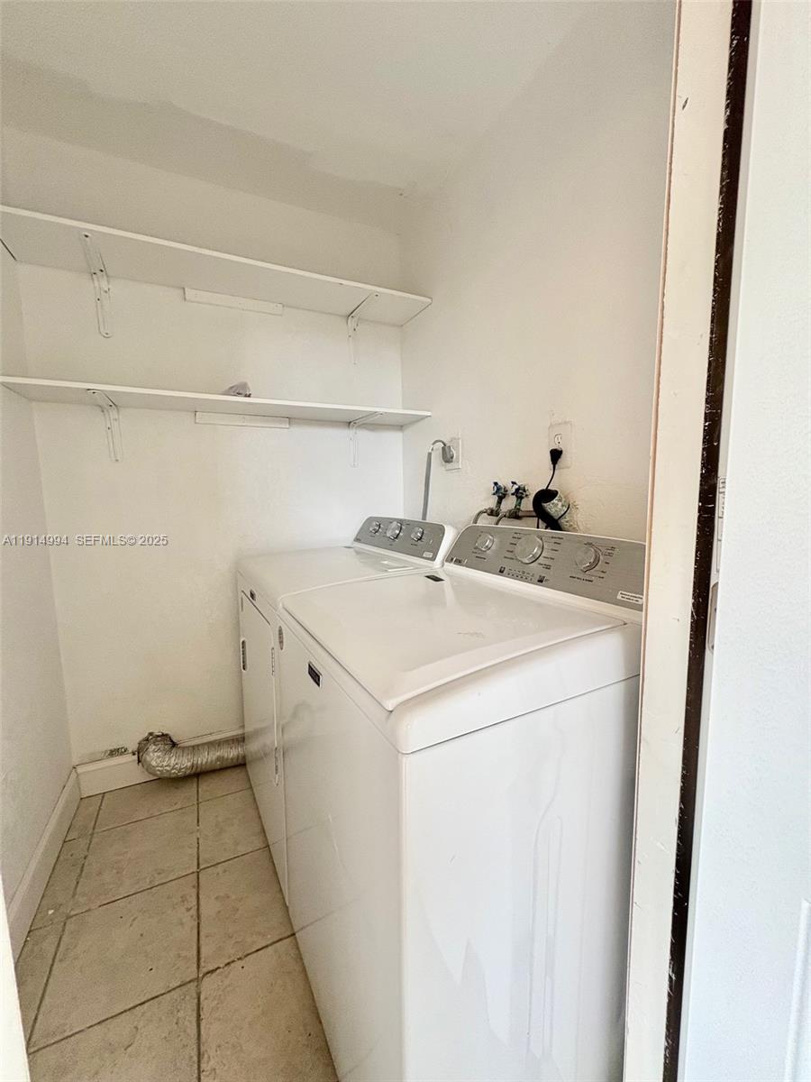 6568 Southwest 41st Place, Unit 151 Davie, FL 33314 - Photo 56 of 65 a utility room with dryer and washer