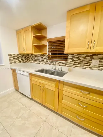 a stove top oven sitting inside of a kitchen
