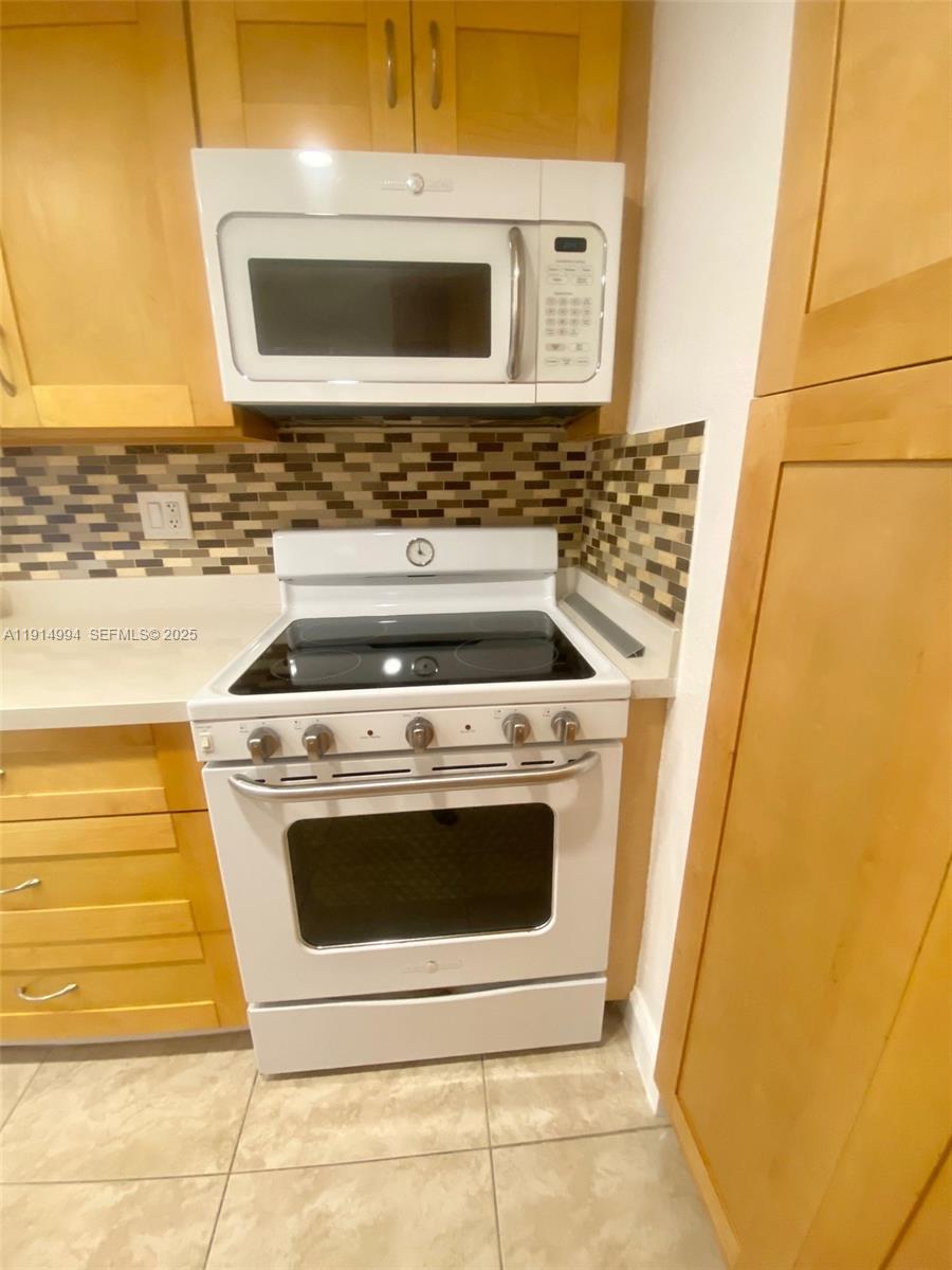 6568 Southwest 41st Place, Unit 151 Davie, FL 33314 - Photo 9 of 65 a stove top oven sitting inside of a kitchen