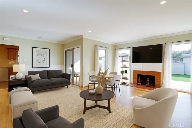a living room with furniture a flat screen tv and a fireplace