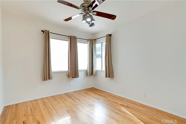 a view of a room with a window and a ceiling fan