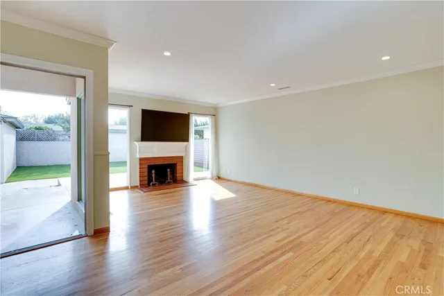 a view of a livingroom with a fireplace a fireplace and wooden floor