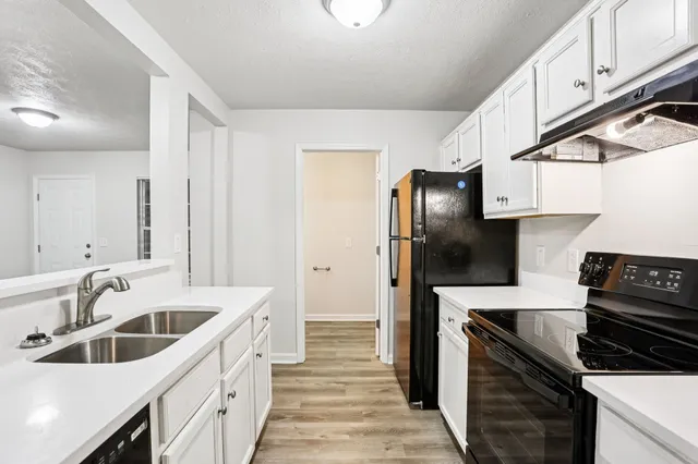 a kitchen with a sink cabinets and stainless steel appliances