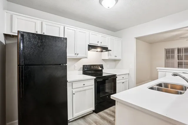 a kitchen with a refrigerator stove and microwave