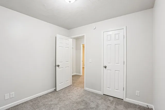 an empty room with closet area