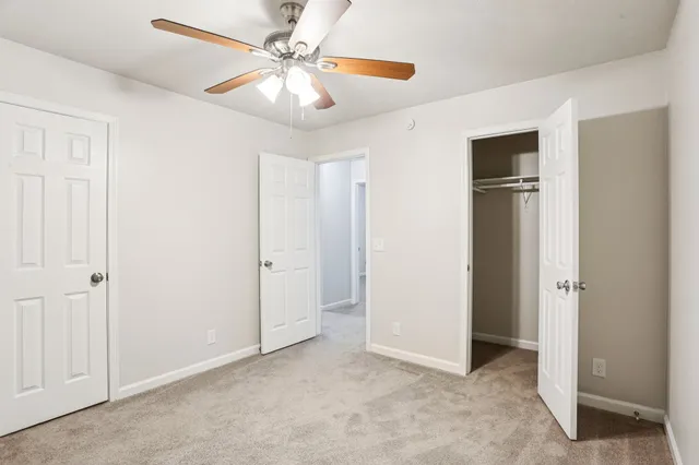 a view of an empty room with a ceiling fan