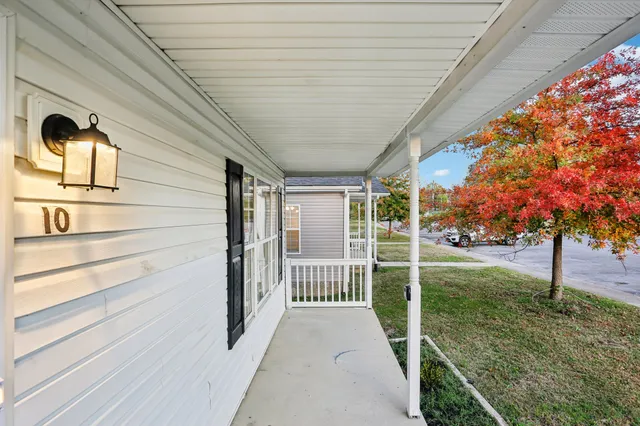 a view of a porch with wooden floor and fence