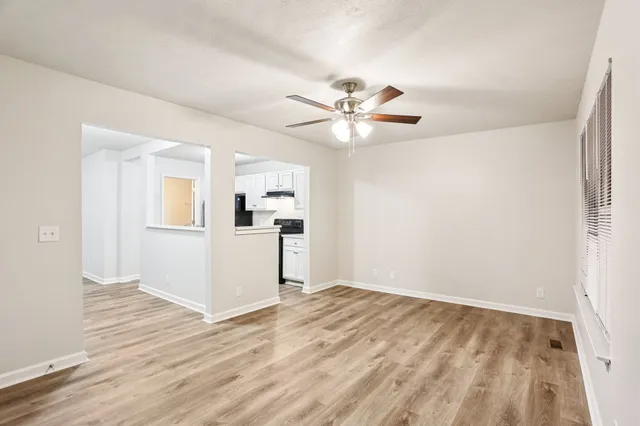 wooden floor in an empty room with a window