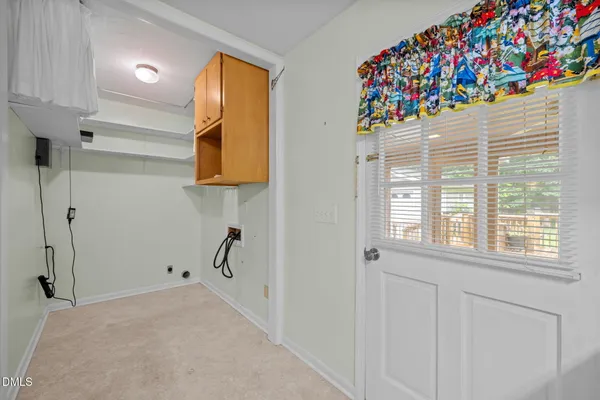 an empty room with windows and ceiling fan
