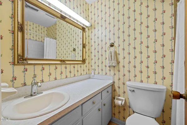 a bathroom with a shower curtain and a sink