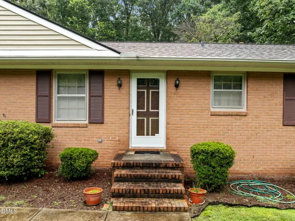 a front view of a house with plants