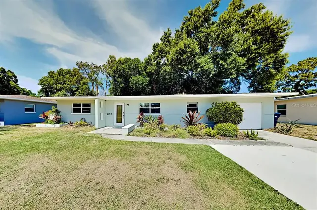 a backyard of a house with table and chairs