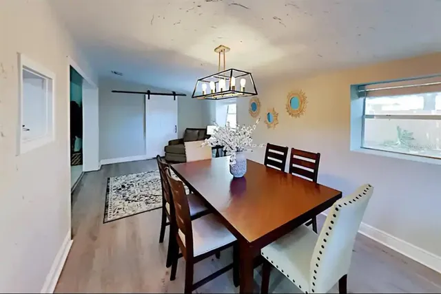 a view of a dining room with furniture window and wooden floor