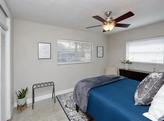 a bedroom with a bed and a chair