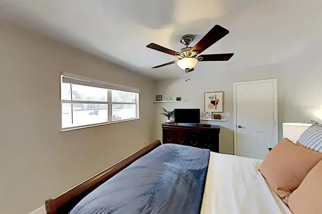 a bedroom with a bed and a window