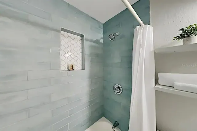 a bathroom with a shower and a toilet
