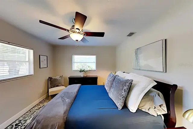 a bedroom with a bed and a chandelier