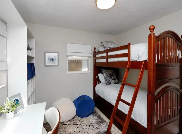 a bedroom with furniture and a baby crib