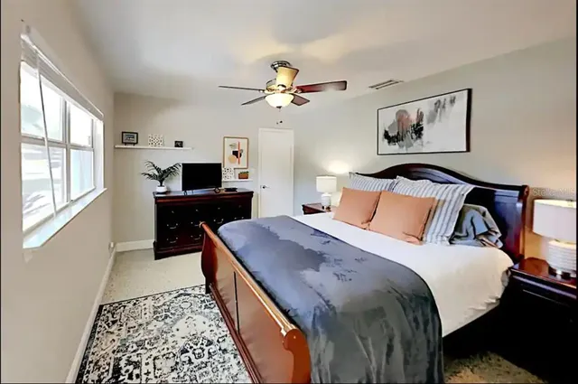 a bed room with a bed and a chandelier