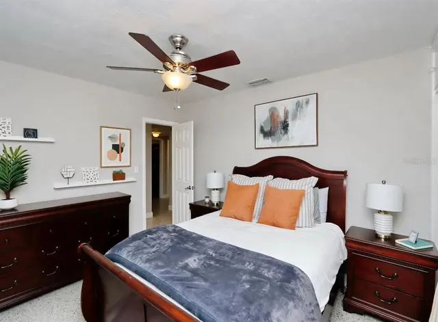 a bedroom with a bed and a dresser