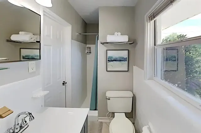 a white toilet sitting next to a bathroom sink