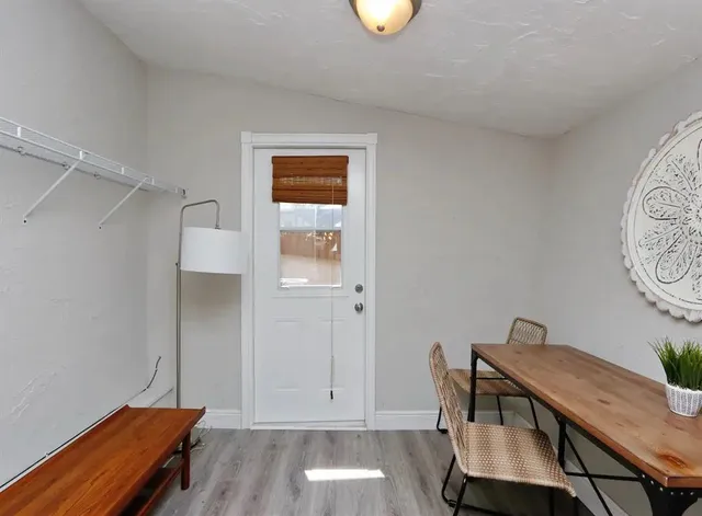 a view of a workspace with furniture and wooden floor