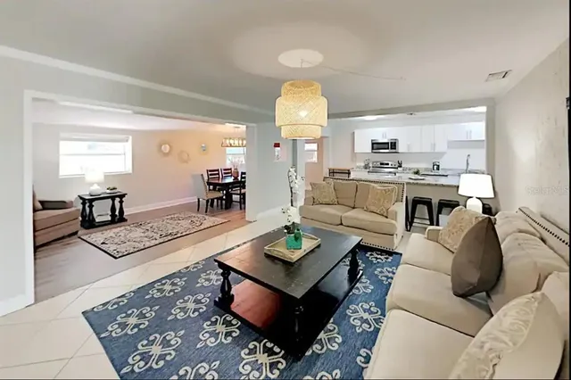 a living room with furniture and a chandelier