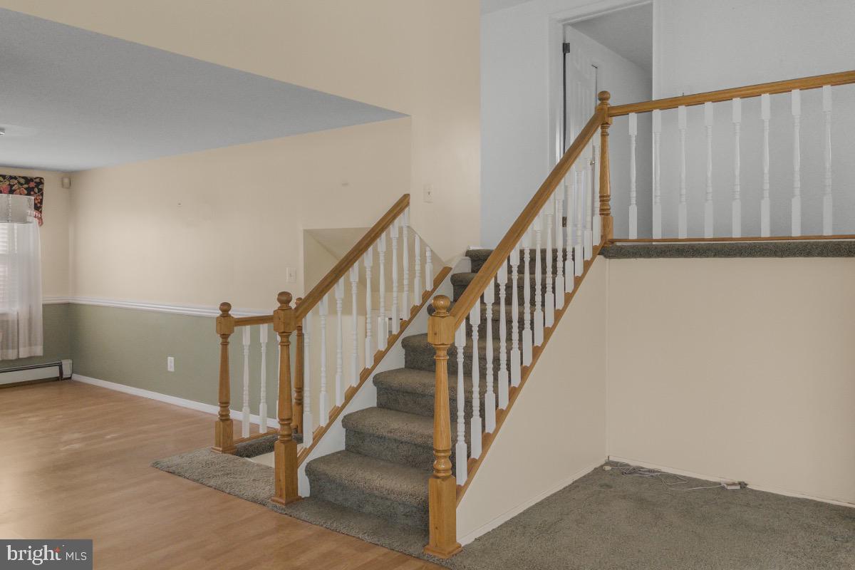 155 Locust Avenue Hamilton, NJ 08610 - Photo 9 of 25 a view of staircase with lots of frames on wall and stairs