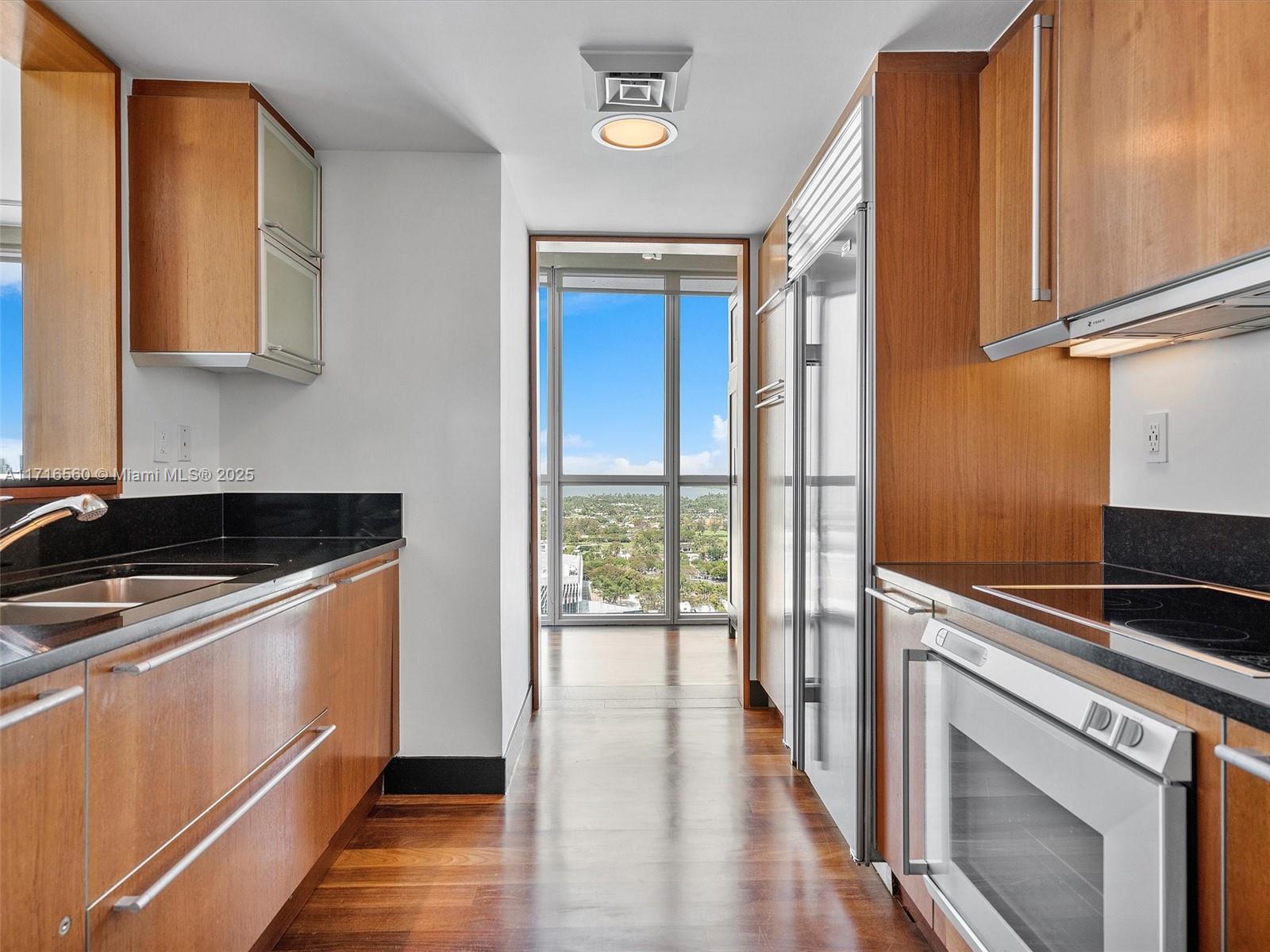 101 20th Street, Unit 3302 Miami Beach, FL 33139 - Photo 15 of 48 a kitchen with stainless steel appliances granite countertop a stove and a refrigerator