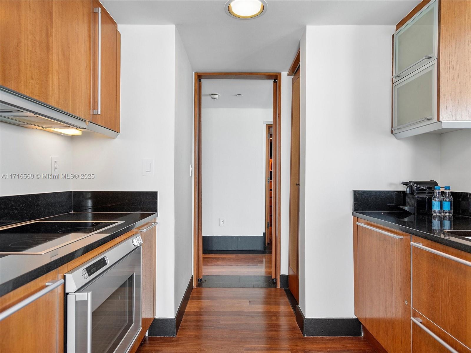 101 20th Street, Unit 3302 Miami Beach, FL 33139 - Photo 17 of 48 a kitchen with stainless steel appliances granite countertop a refrigerator and a stove top oven