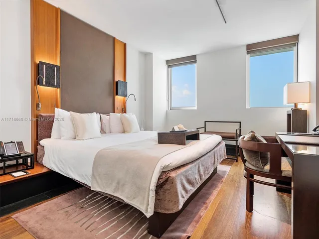 a bedroom with bed and a night stand on dresser