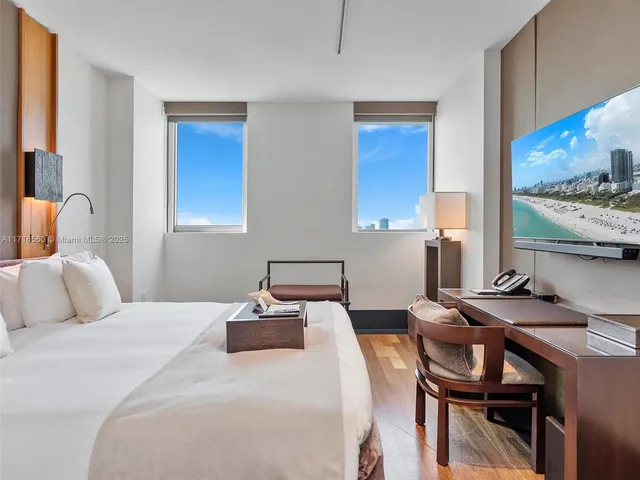 a bedroom with a bed and a table