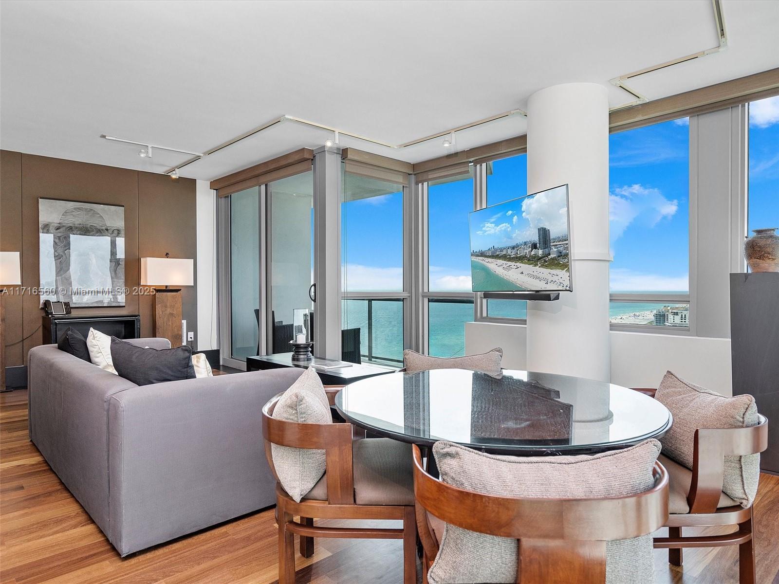 101 20th Street, Unit 3302 Miami Beach, FL 33139 - Photo 2 of 48 a living room with fireplace furniture and a table