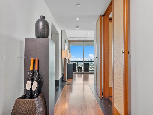 a view of a hallway with furniture and a livingroom view