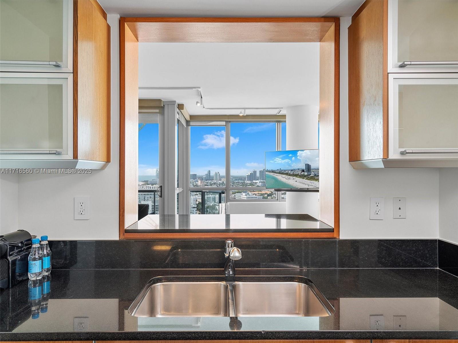 101 20th Street, Unit 3302 Miami Beach, FL 33139 - Photo 22 of 48 a kitchen view with granite countertop a sink and a counter top space